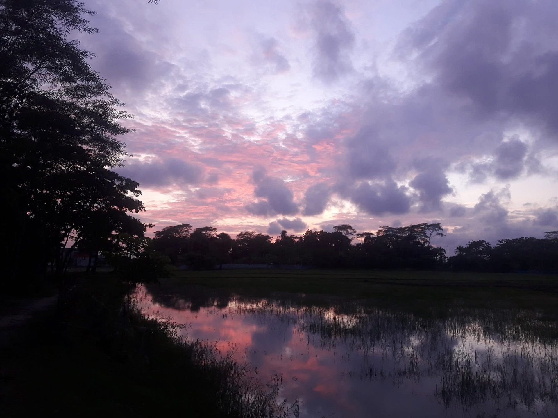 Clouds gathering over reflective water
