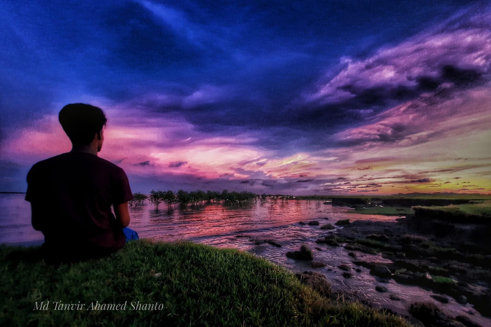 A purple sunset reflected across a river